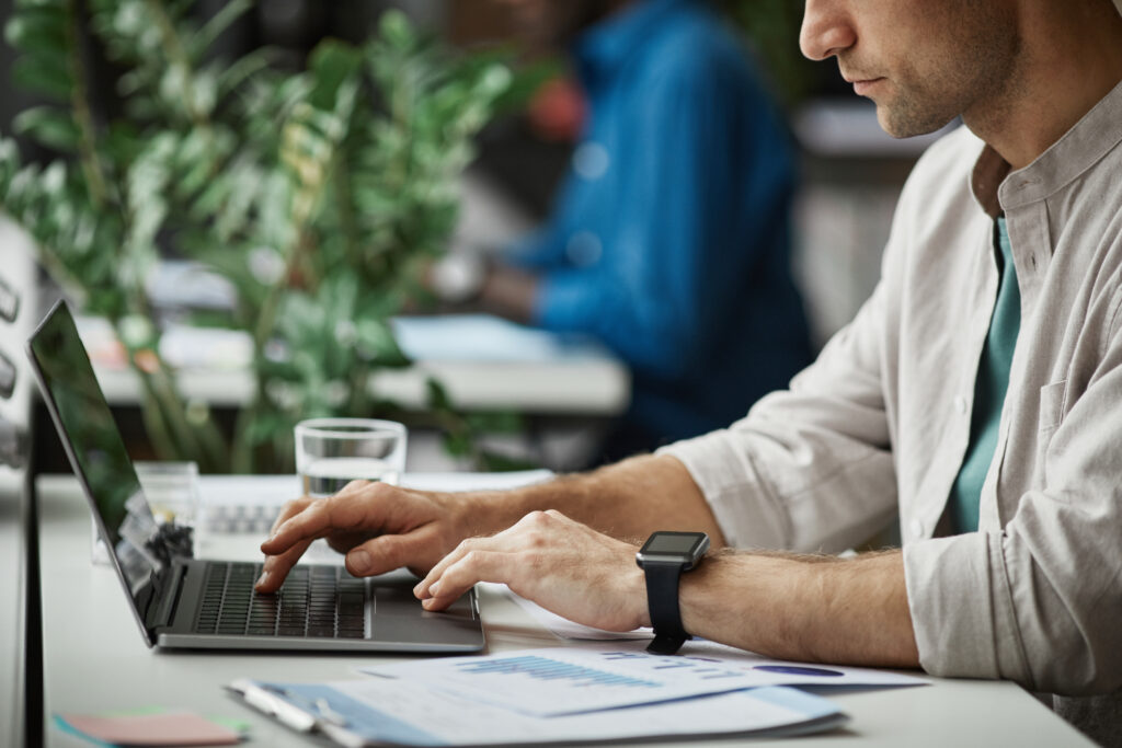man reviewing employment contract on computer related to breach of contract workplace issue