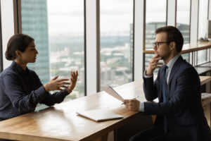 Woman meeting with HR representative about a workplace harassment complaint