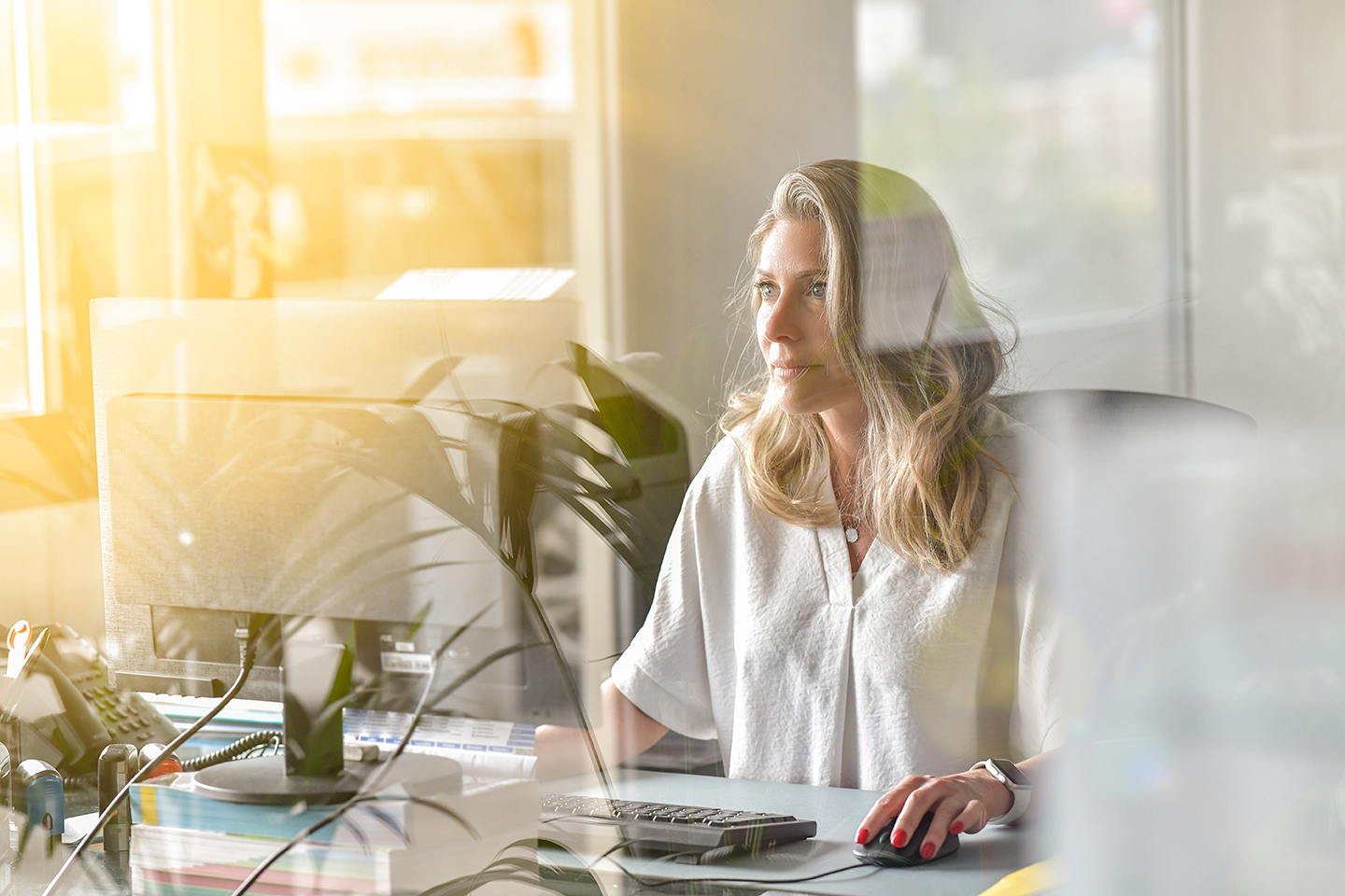 
Employee working at desk noticing changes in workplace treatment