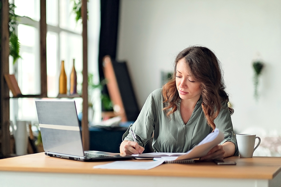 Employee documenting workplace retaliation at her desk in California